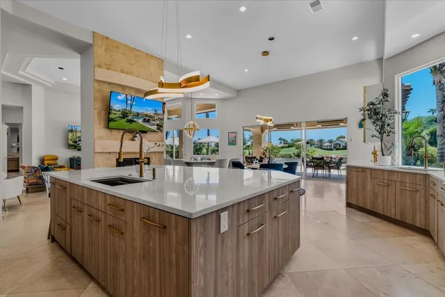 a view of a chair and tables in the patio in front of a house