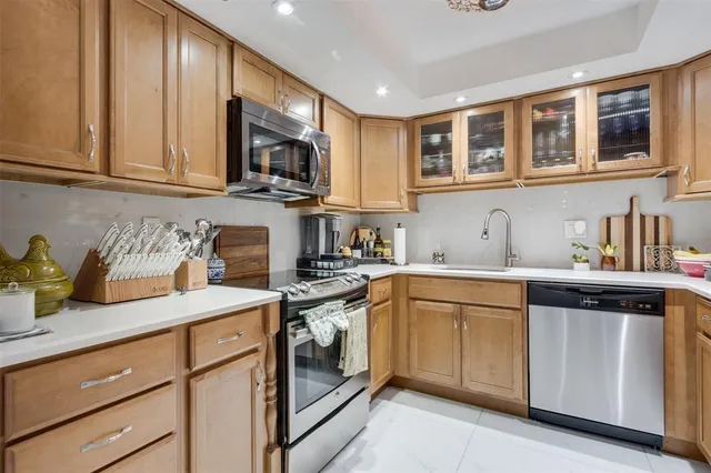 a kitchen with stainless steel appliances granite countertop a refrigerator and a sink