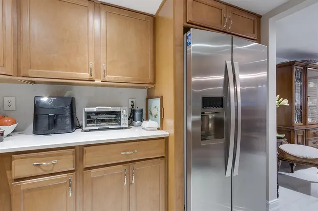 a kitchen with stainless steel appliances granite countertop a refrigerator a stove top oven a sink and dishwasher