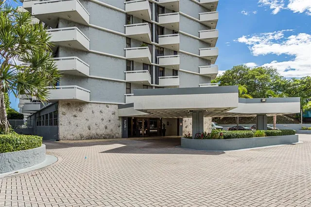 a front view of a building with a garden