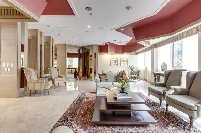 a living room with furniture fireplace and a large window