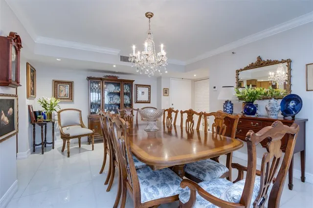a view of a dining room with furniture and chandelier