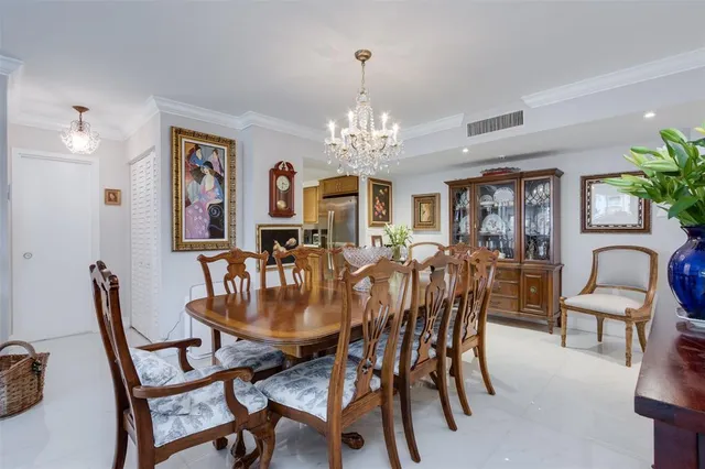 a dining room with furniture a chandelier and window