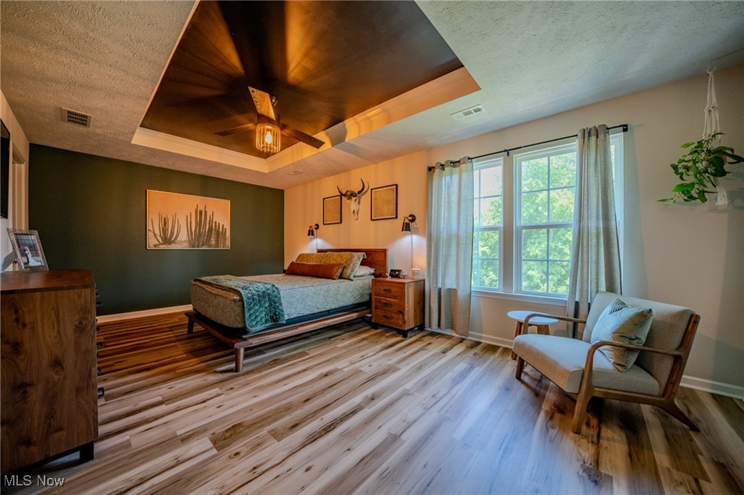 270 Stone Ridge Way Berea, OH 44017 - Photo 22 of 30 Bedroom featuring a raised ceiling, a textured ceiling, wood-type flooring, and ceiling fan