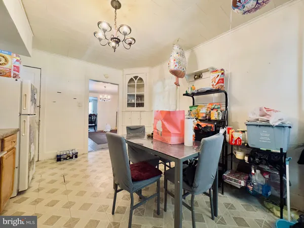 a view of a dining room with furniture and a chandelier