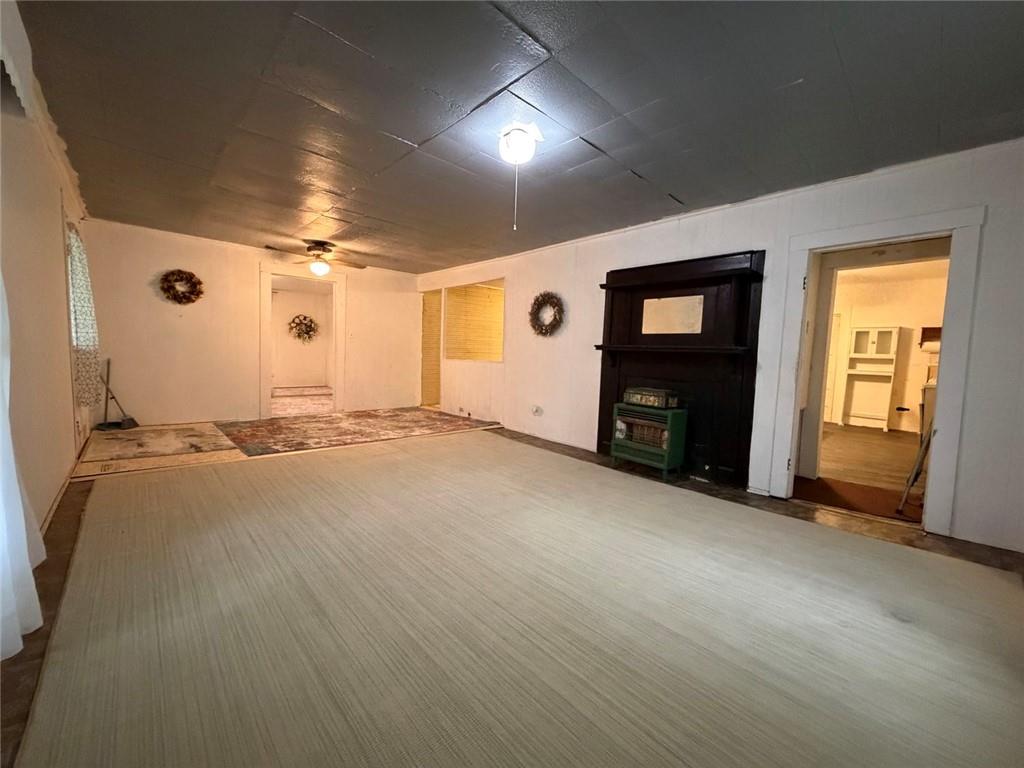 209 Old Perry Road Marshallville, GA 31057 - Photo 34 of 40 an empty room with fireplace and windows
