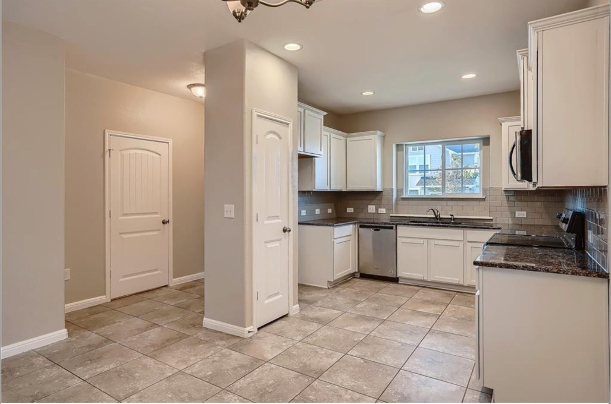 304 Cane River Road Pflugerville, TX 78660 - Photo 5 of 31 A well-equipped kitchen boasts granite counters, stainless steel appliances, and ample white cabinetry.