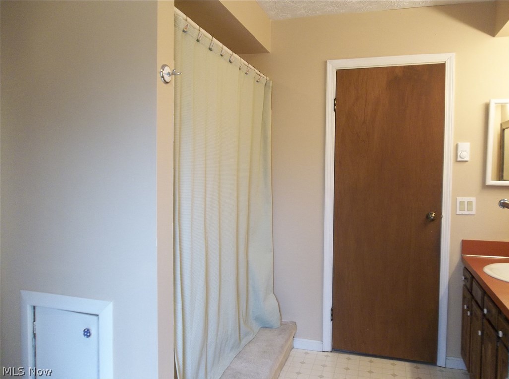 70 Boulder Ridge Place Painesville, OH 44077 - Photo 16 of 26 The shower is directly behind the vanity area with shower curtain & access panel for the pipes!