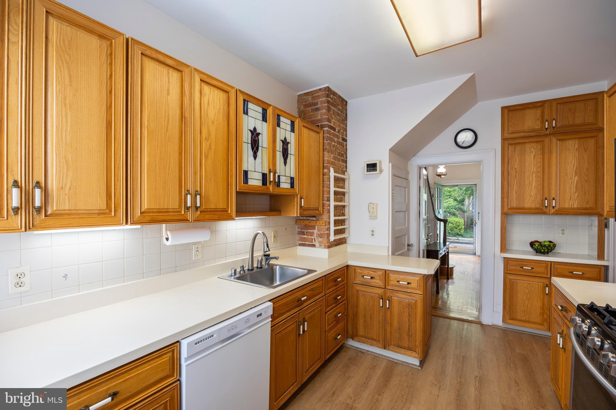 3936 Cloverhill Road Baltimore, MD 21218 - Photo 13 of 37 a kitchen with a sink a counter top space and cabinets