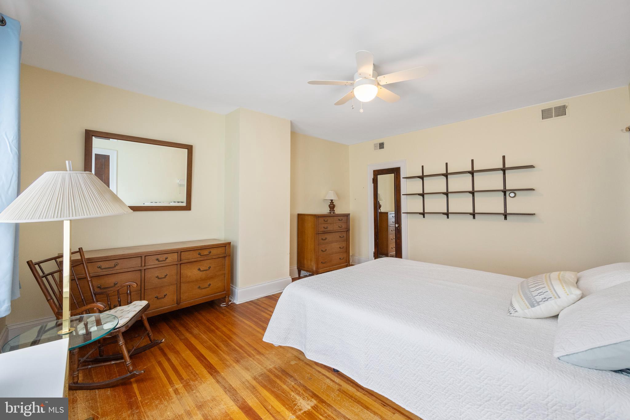 3936 Cloverhill Road Baltimore, MD 21218 - Photo 17 of 37 a bedroom with a bed and a chandelier