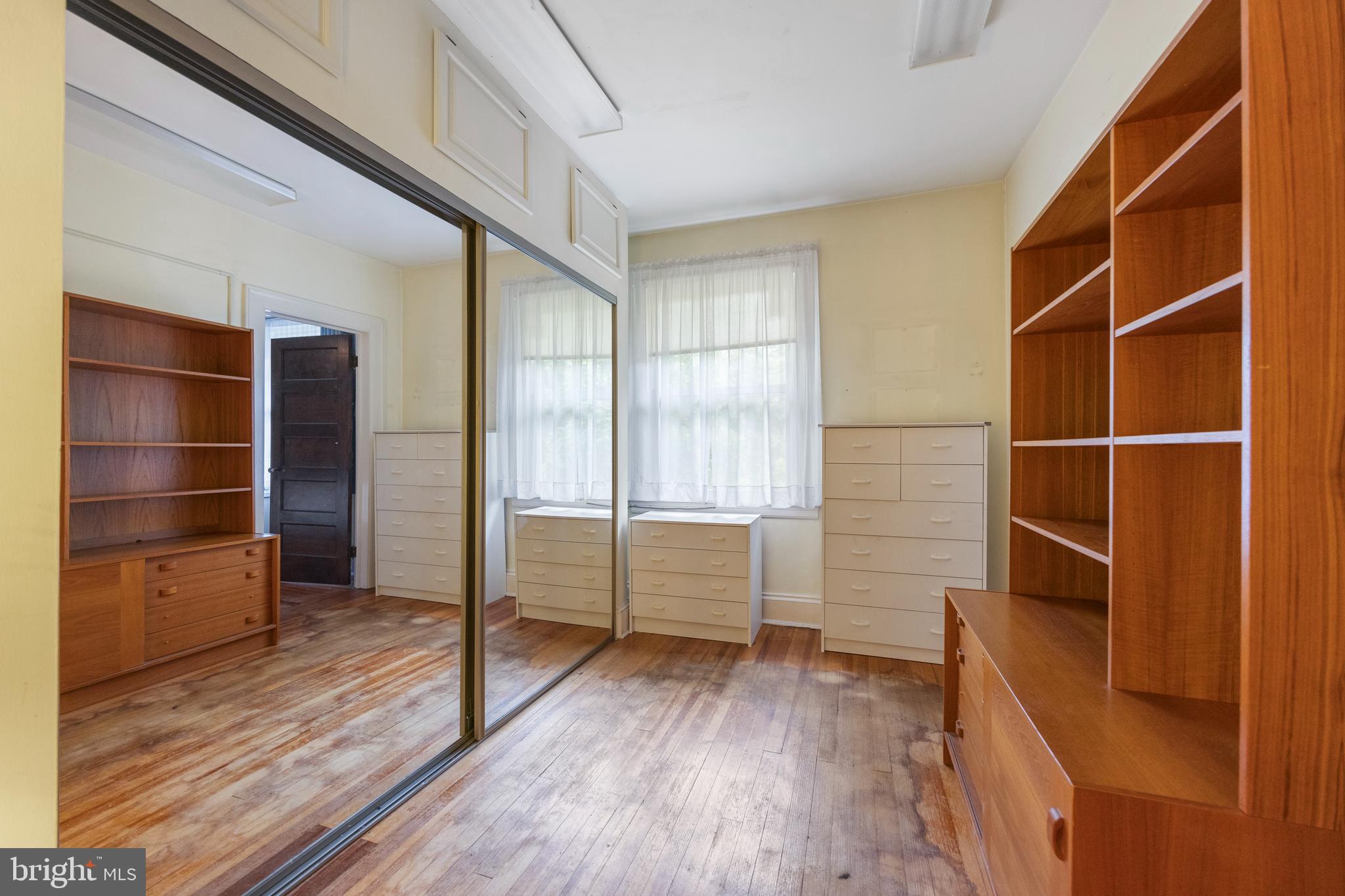 3936 Cloverhill Road Baltimore, MD 21218 - Photo 19 of 37 a room with walk in closet and wooden floor
