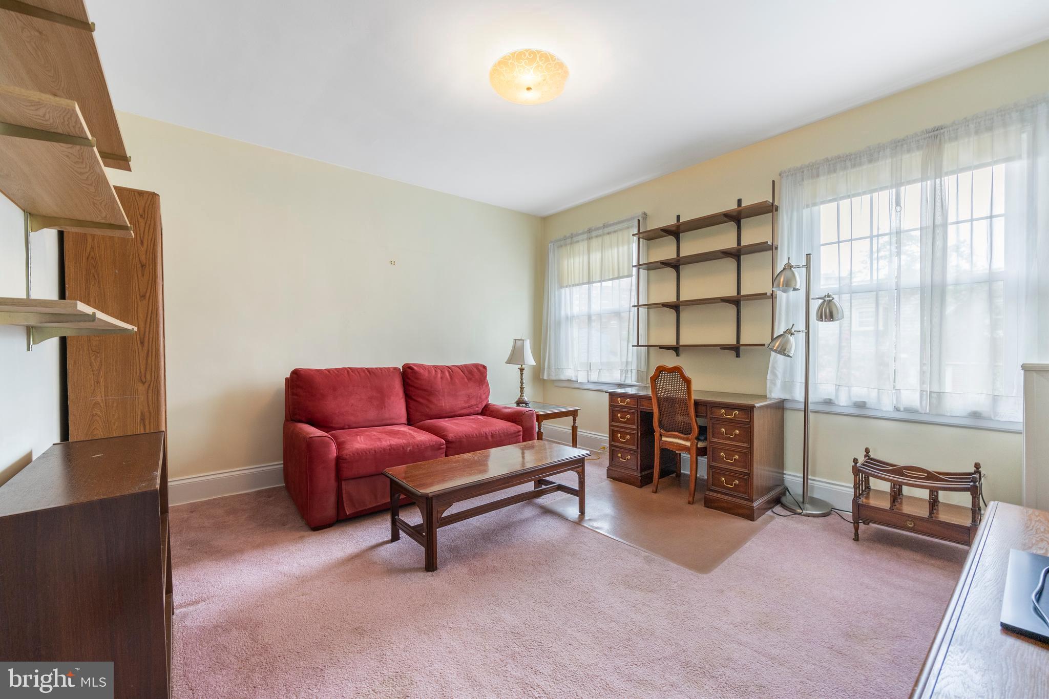 3936 Cloverhill Road Baltimore, MD 21218 - Photo 20 of 37 a living room with furniture a dining table and a fireplace next to a window