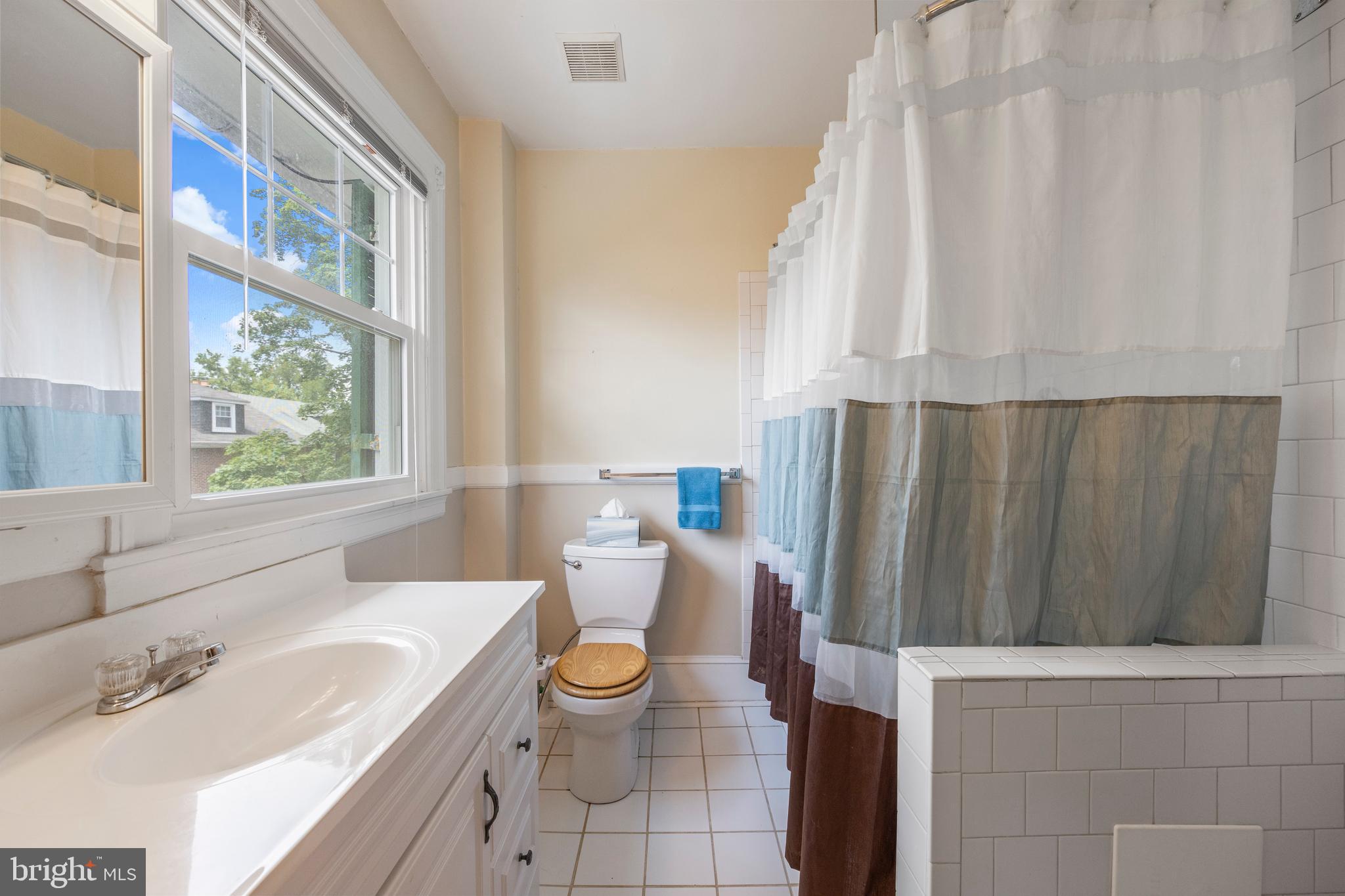 3936 Cloverhill Road Baltimore, MD 21218 - Photo 24 of 37 a bathroom with a sink a toilet and tub