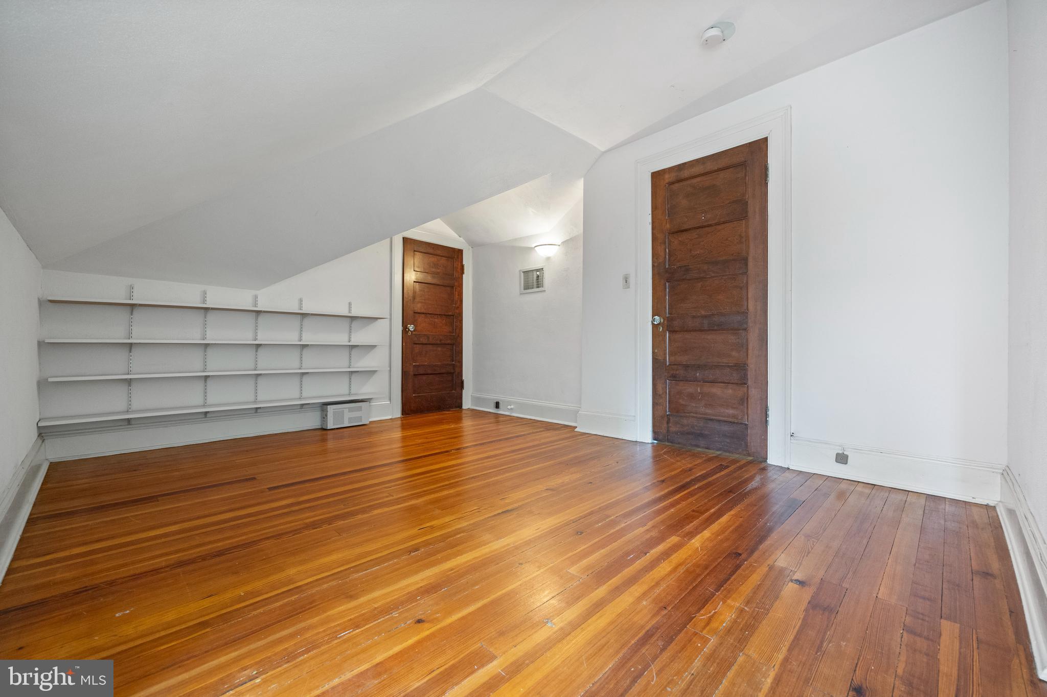 3936 Cloverhill Road Baltimore, MD 21218 - Photo 25 of 37 a view of empty room with wooden floor and cabinet