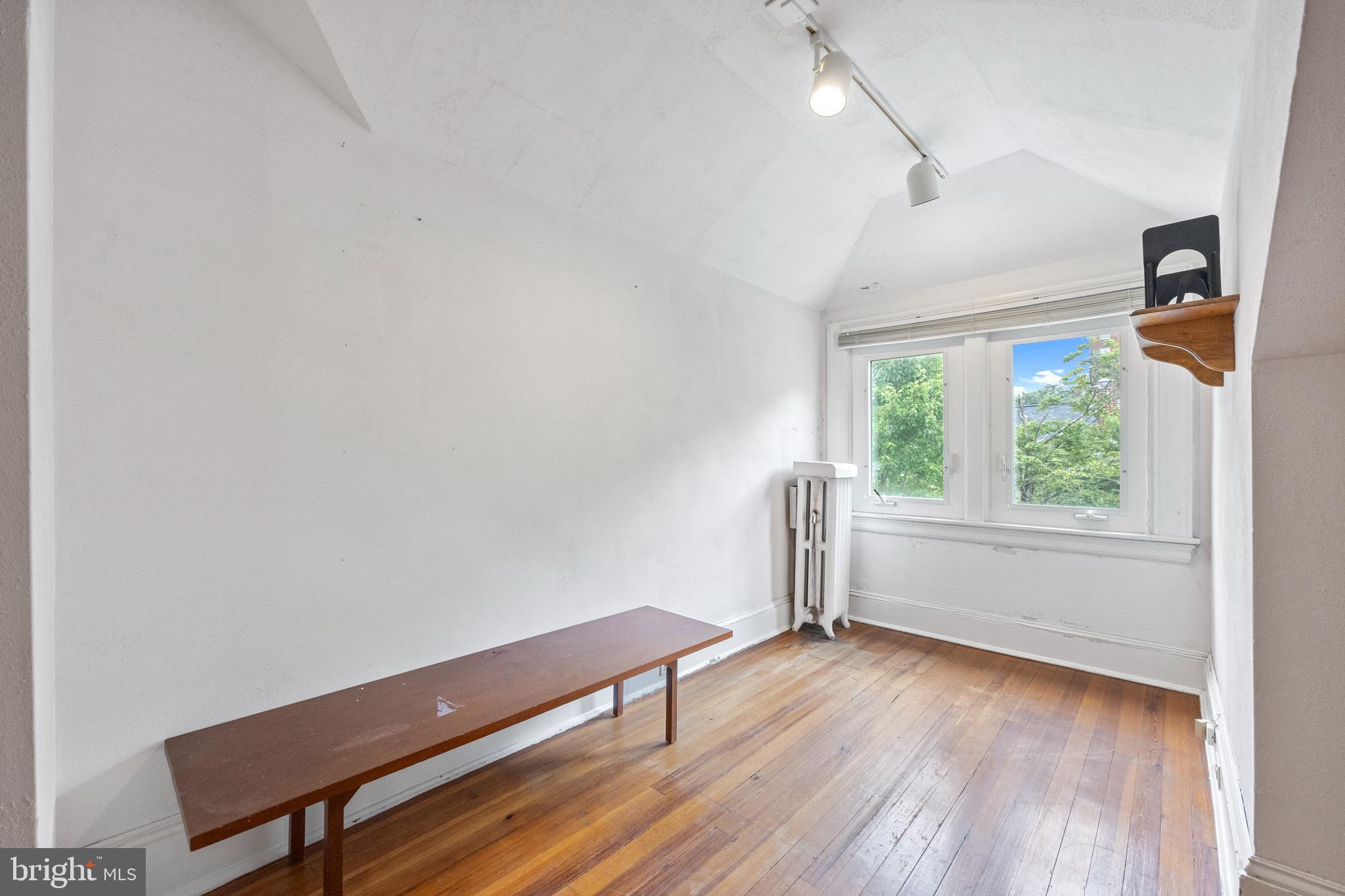 3936 Cloverhill Road Baltimore, MD 21218 - Photo 26 of 37 a view of a room with wooden floor and windows
