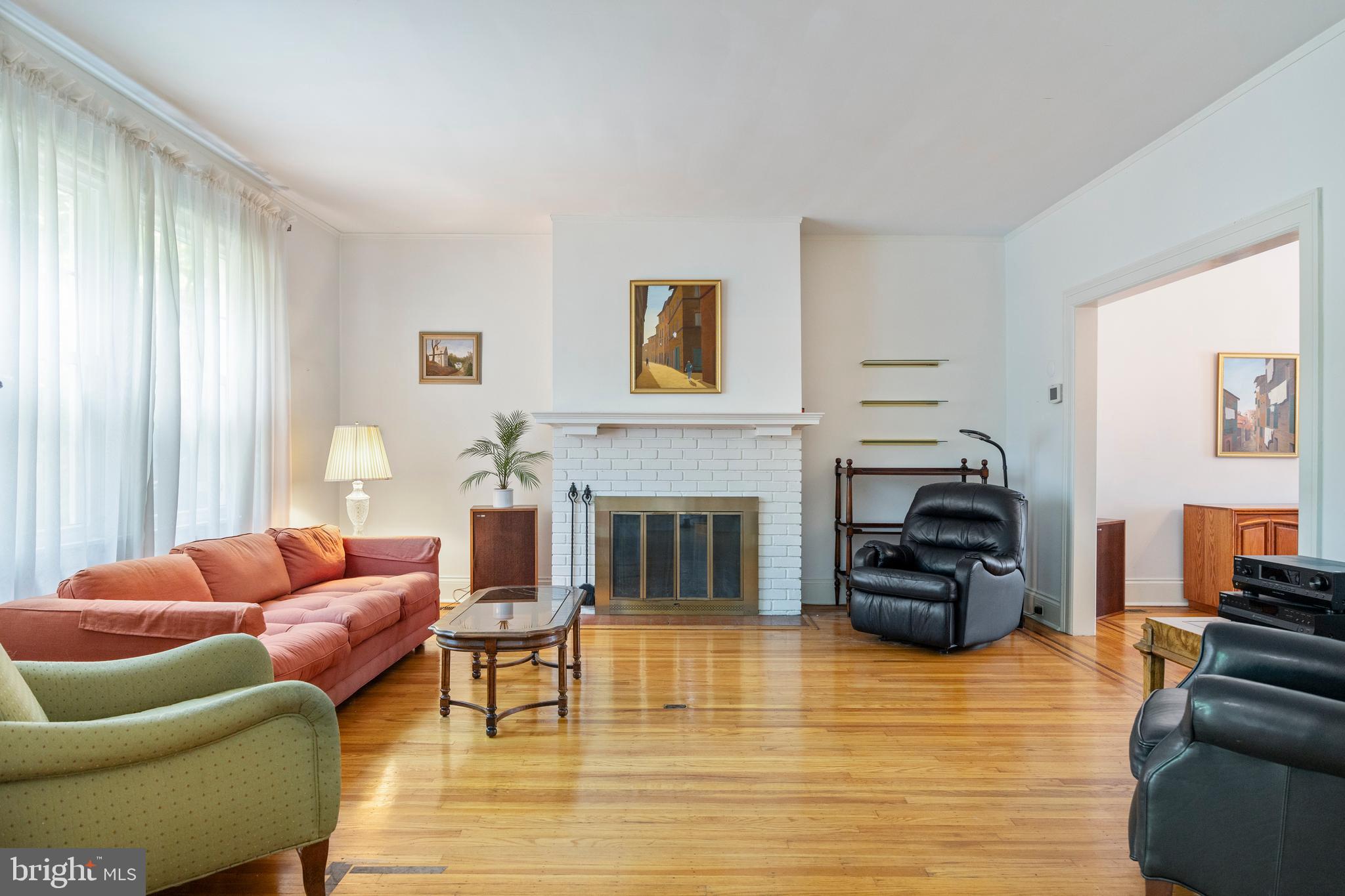 3936 Cloverhill Road Baltimore, MD 21218 - Photo 4 of 37 a living room with furniture a fireplace and a large window