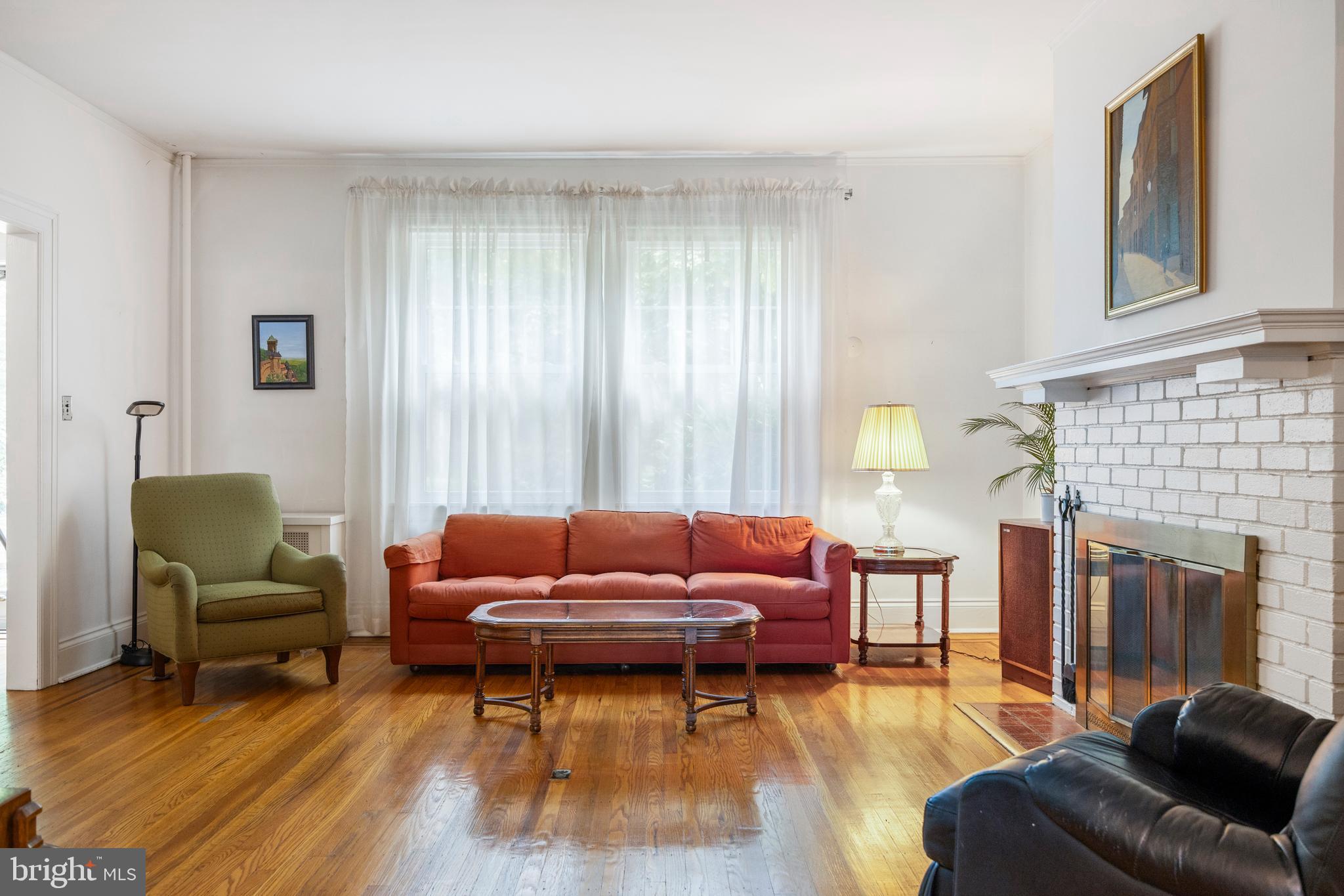 3936 Cloverhill Road Baltimore, MD 21218 - Photo 6 of 37 a living room with furniture window and a fireplace