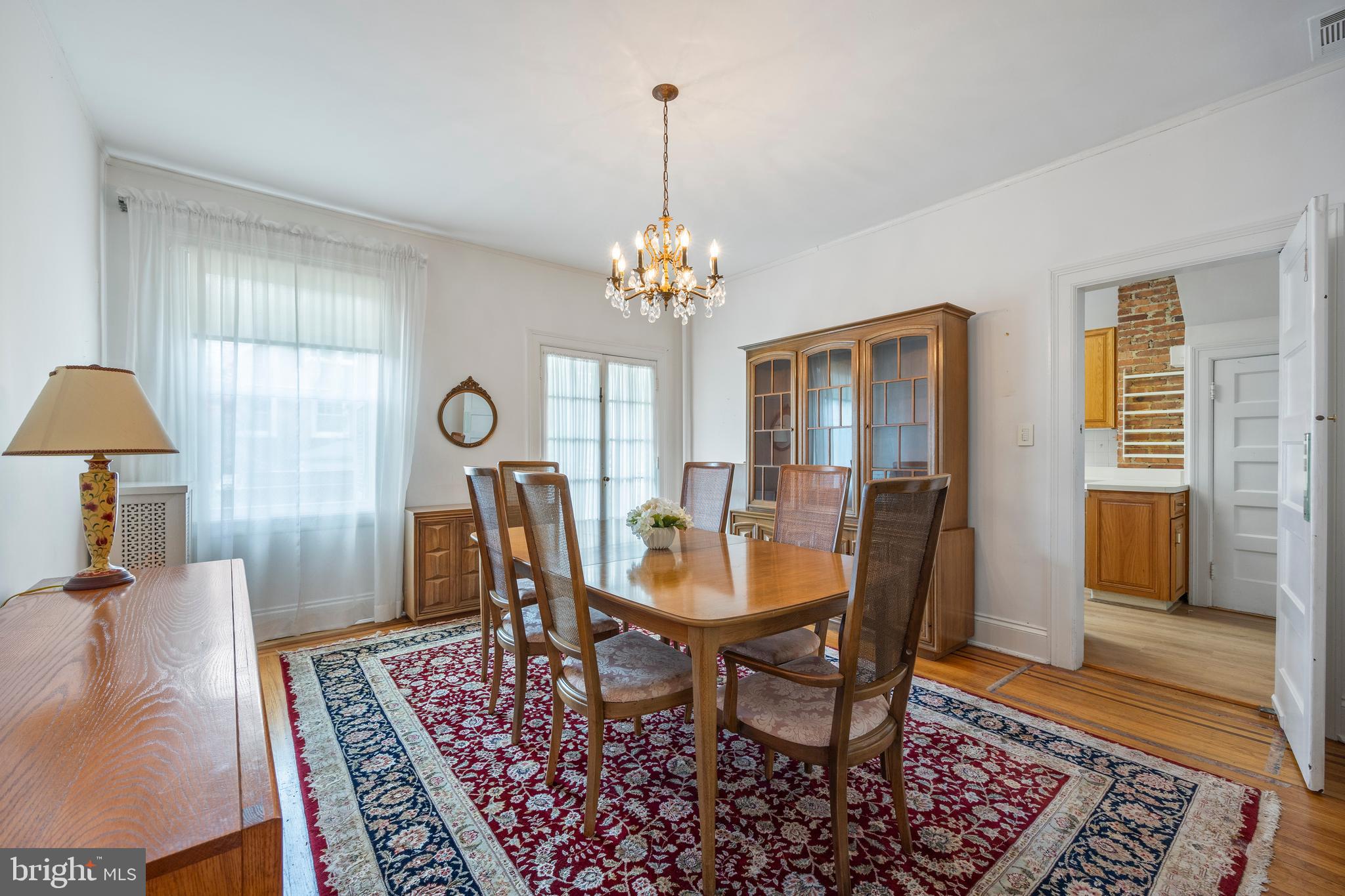 3936 Cloverhill Road Baltimore, MD 21218 - Photo 8 of 37 a view of a dining room with furniture and a window