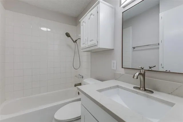 a bathroom with a sink a toilet and bathtub