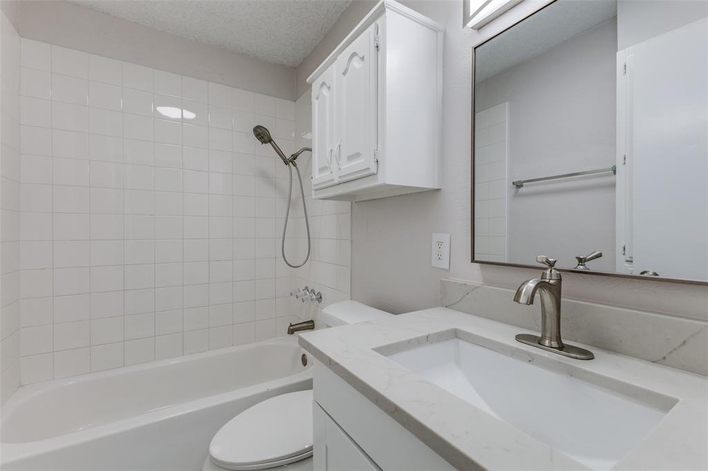 3921 Ambassador Way Balch Springs, TX 75180 - Photo 20 of 25 a bathroom with a sink a toilet and bathtub