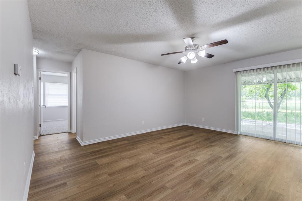 3921 Ambassador Way Balch Springs, TX 75180 - Photo 6 of 25 wooden floor in an empty room with a window