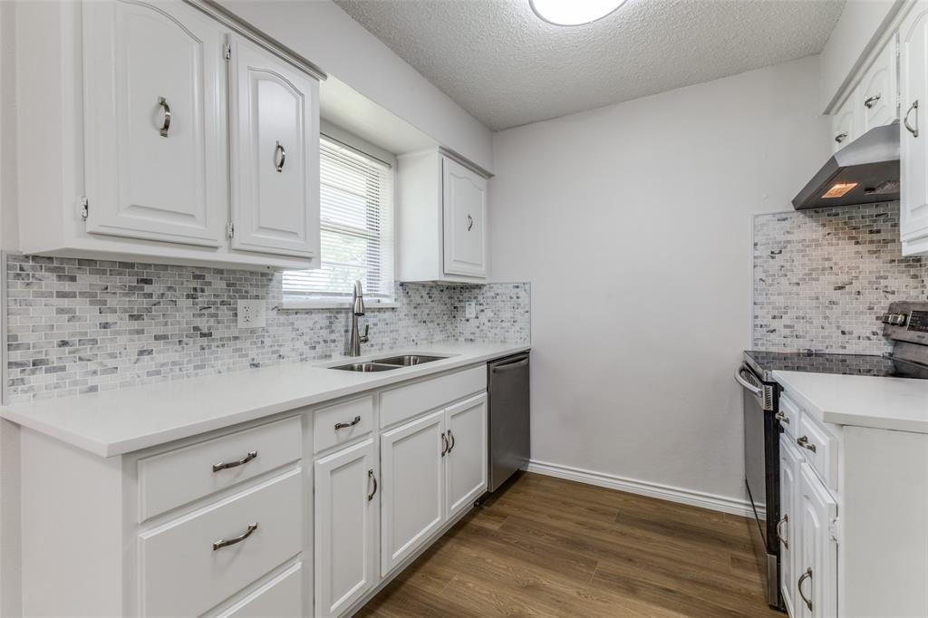 3921 Ambassador Way Balch Springs, TX 75180 - Photo 8 of 25 a kitchen with granite countertop white cabinets and white appliances