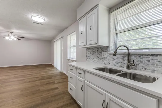 a kitchen with a sink cabinets and window