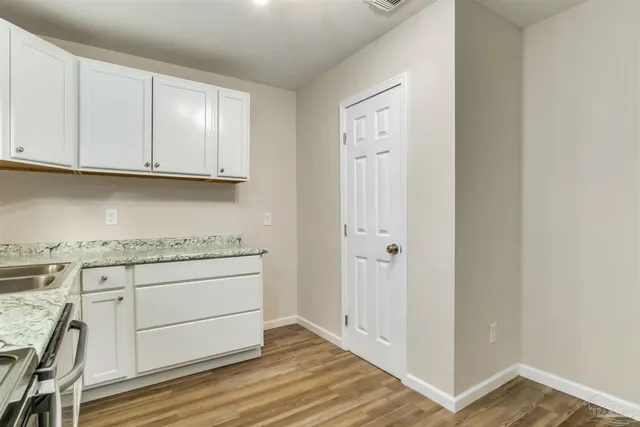 a view of cabinets with wooden floor