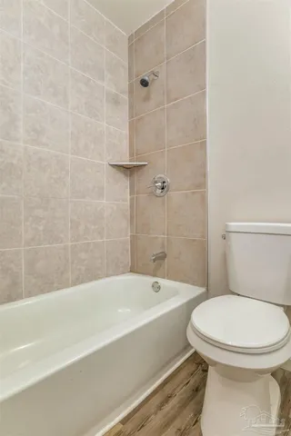 a bathroom with a toilet and a bath tub