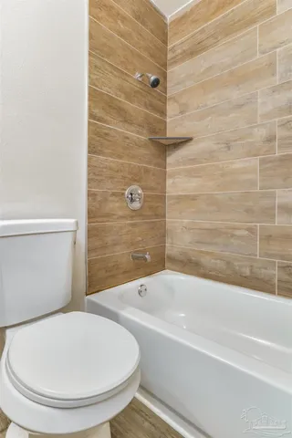 a bathroom with a toilet and a bathtub