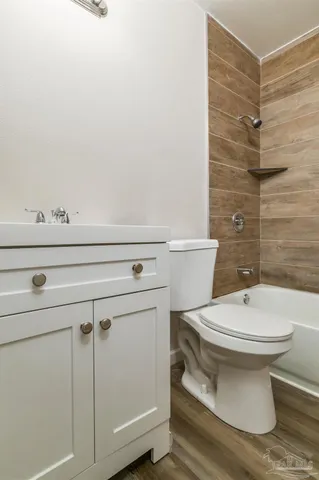 a bathroom with a toilet a sink and shower