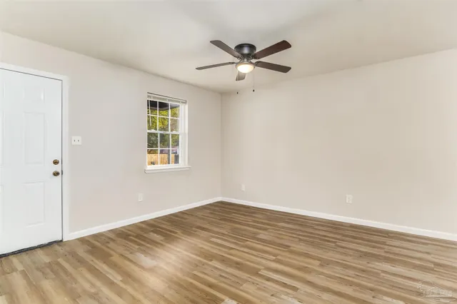 a view of a big room with wooden floor closet and windows