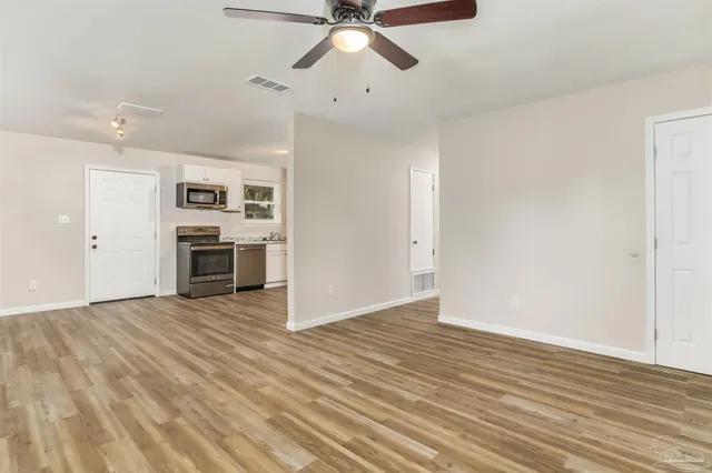 wooden floor in an empty room with a fireplace