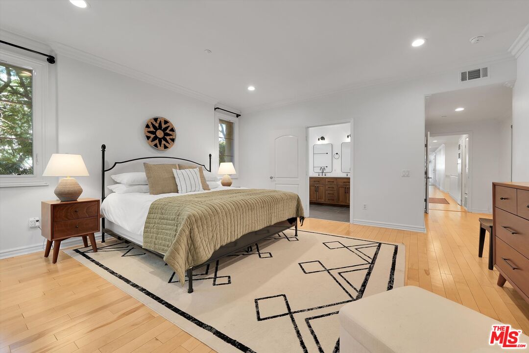 1601 South Bentley Avenue, Unit 211 Los Angeles, CA 90025 - Photo 12 of 30 a bedroom with a bed and wooden floor