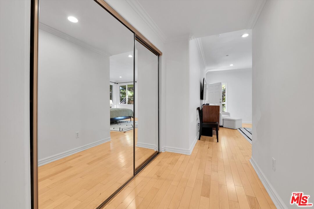 1601 South Bentley Avenue, Unit 211 Los Angeles, CA 90025 - Photo 18 of 30 a view of a hallway with wooden floor and a living room