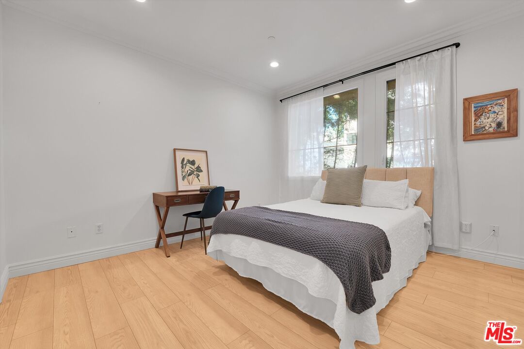 1601 South Bentley Avenue, Unit 211 Los Angeles, CA 90025 - Photo 19 of 30 a bedroom with a bed and wooden floor