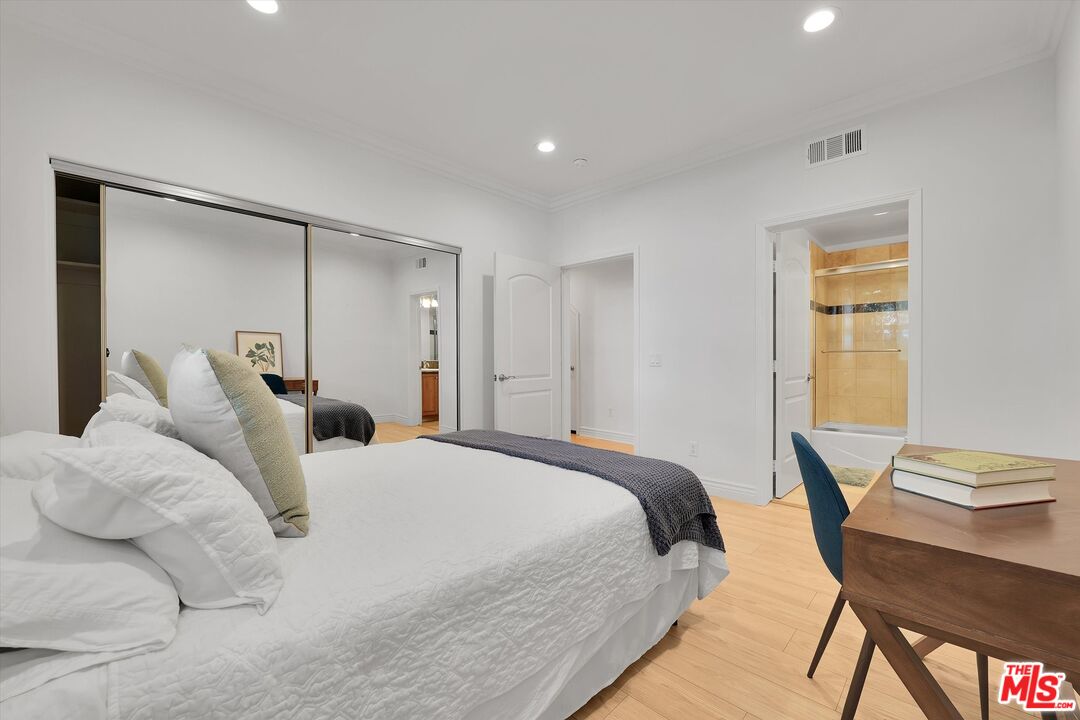 1601 South Bentley Avenue, Unit 211 Los Angeles, CA 90025 - Photo 20 of 30 a bedroom with a bed and a table