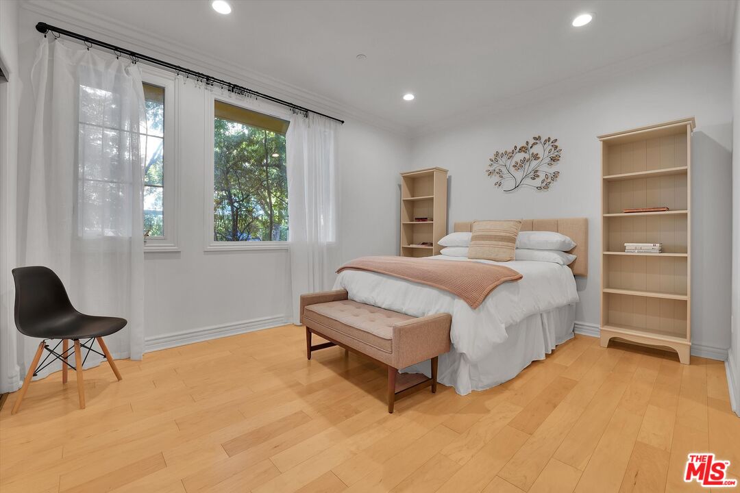 1601 South Bentley Avenue, Unit 211 Los Angeles, CA 90025 - Photo 22 of 30 a bedroom with a bed and a chair