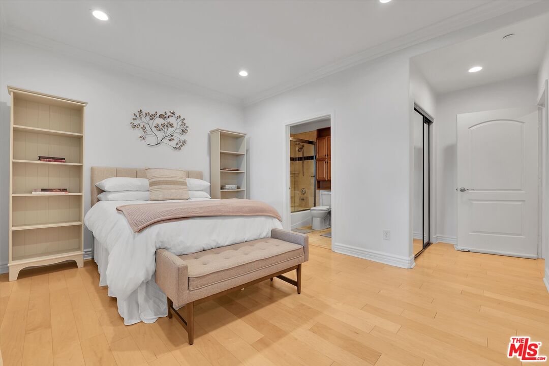 1601 South Bentley Avenue, Unit 211 Los Angeles, CA 90025 - Photo 23 of 30 a bedroom with a bed and painting on the wall