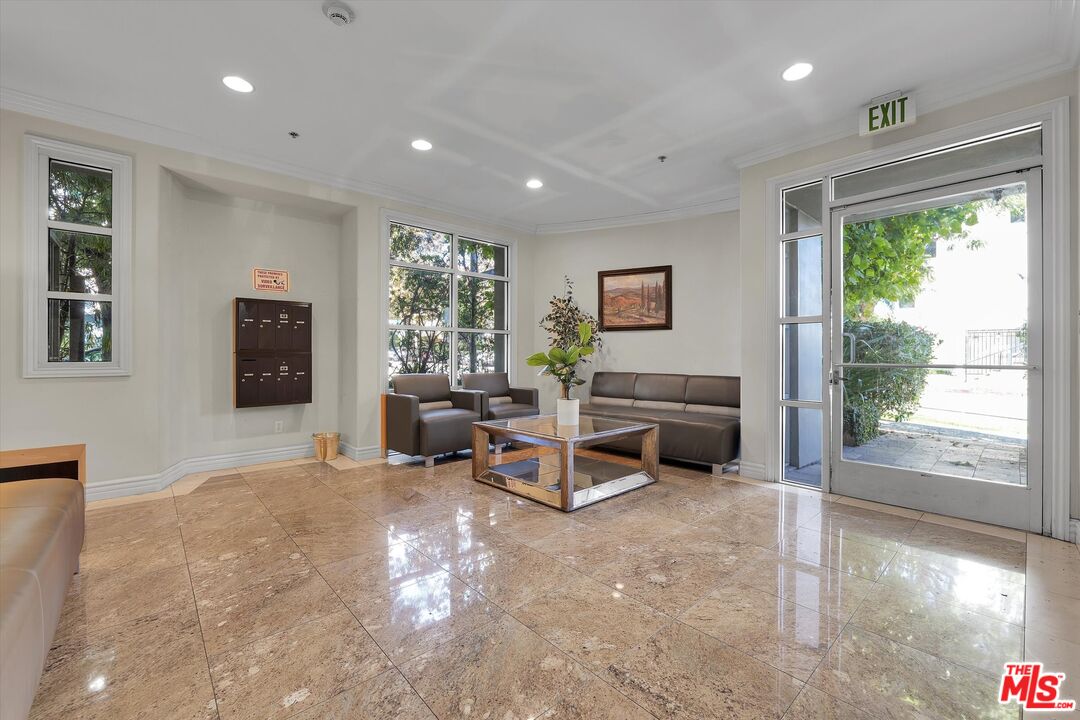 1601 South Bentley Avenue, Unit 211 Los Angeles, CA 90025 - Photo 27 of 30 a living room with furniture and a large window