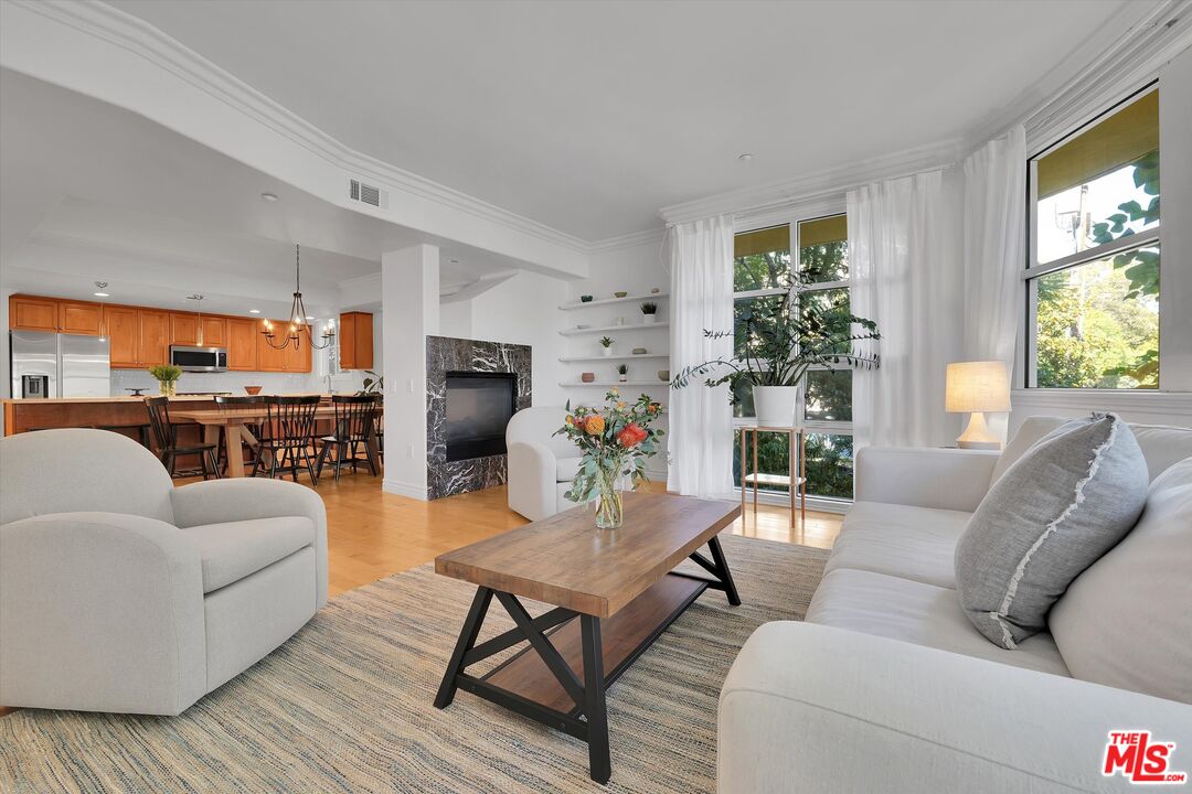 1601 South Bentley Avenue, Unit 211 Los Angeles, CA 90025 - Photo 3 of 30 a living room with furniture and a flat screen tv