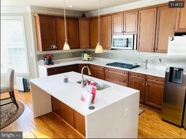 a kitchen that has a sink and a stove in it