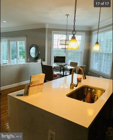 a kitchen with a sink a counter space and a window