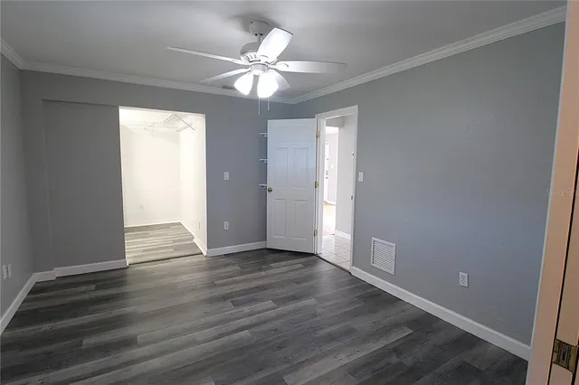 a view of an empty room with wooden floor