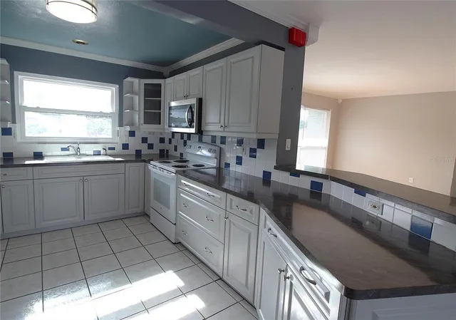 a kitchen with a sink stove and cabinets