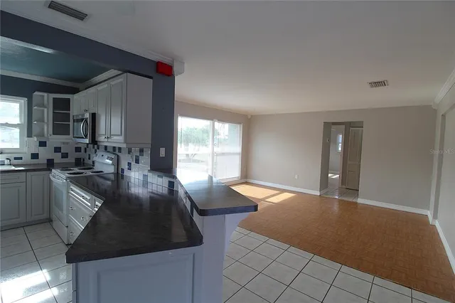 a kitchen with sink and cabinets