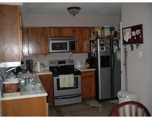 a kitchen with stainless steel appliances granite countertop a refrigerator stove and sink