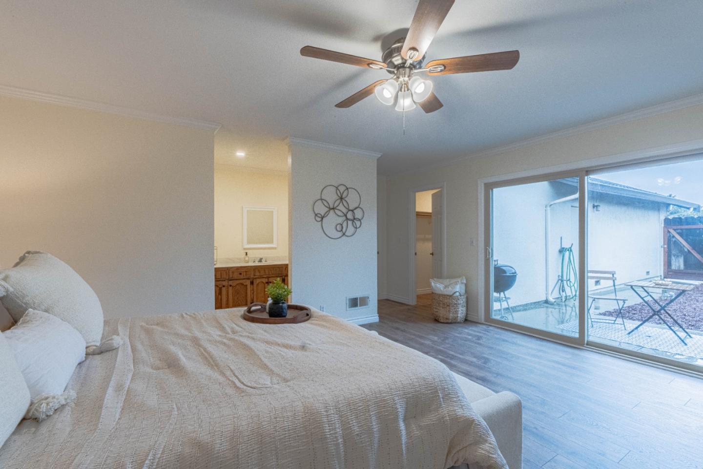 1130 Montecito Circle Salinas, CA 93901 - Photo 19 of 32 a bedroom with a large bed and a chandelier