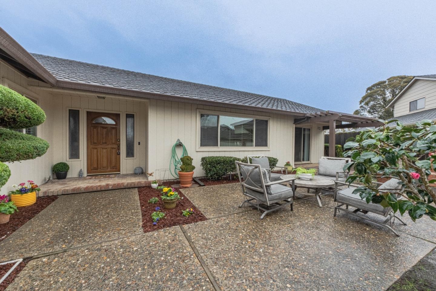 1130 Montecito Circle Salinas, CA 93901 - Photo 2 of 32 a view of a house with backyard sitting area and garden