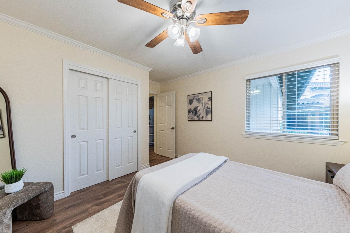 1130 Montecito Circle Salinas, CA 93901 - Photo 24 of 32 a bedroom with a bed and a chandelier